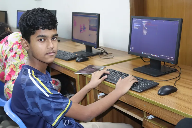A curious learner working with code in the MyeKids classroom